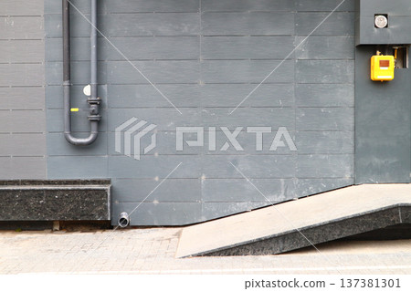 The pipe with a valve on the outside wall. The pipe with a valve on the outside wall. 137381301