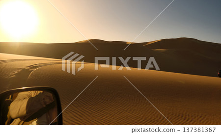 Driving Through Desert Sand Dunes at Sunset 137381367
