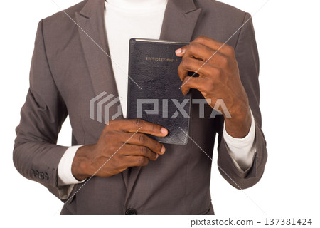 portrait of young man with a Bible in his hand. 137381424