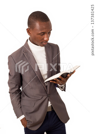 portrait of young man with book in hand. 137381425