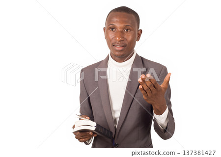 portrait of young man in a suit standing. 137381427