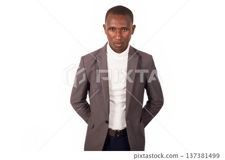 portrait of young man in a suit standing. 137381499