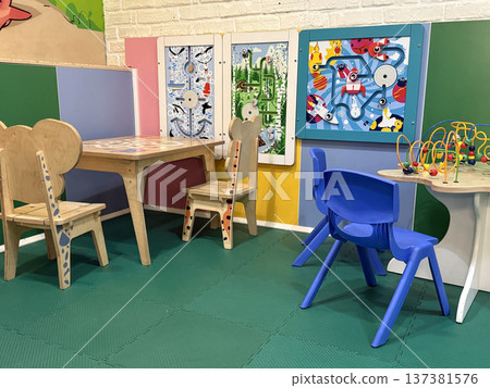 Childrens playroom with colorful furniture and toys for playful activities and learning Childrens playroom with colorful furniture and toys for playful activities and learning 137381576