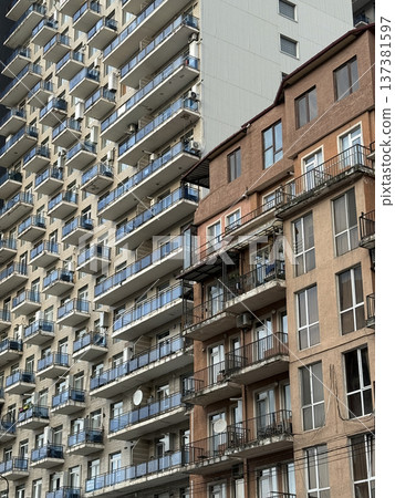 High-rise apartment buildings with contrasting architectural designs in urban setting High-rise apartment buildings with contrasting architectural designs in urban setting 137381597