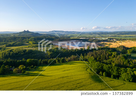 Trosky Castle set against a vast countryside during summer in Bohemian Paradise. Green fields and distant hills create a beautiful landscape in Czechia. 137382899