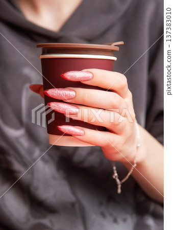 Woman holding paper cup with stylish long nails 137383010