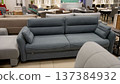 Contemporary fabric sofa for sale in a retail furniture store showroom 137384932