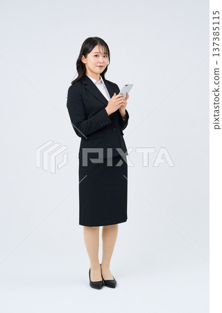Business woman operating a smartphone 137385115
