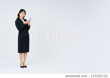 Business woman operating a smartphone 137385119