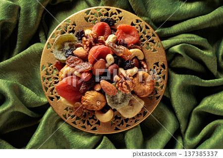 Assortment of dried tropical fruits, nuts and raisins. Assortment of dried tropical fruits, nuts and raisins. 137385337