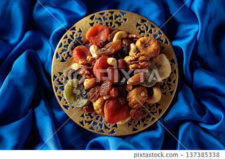 Assortment of dried tropical fruits, nuts and raisins. Assortment of dried tropical fruits, nuts and raisins. 137385338