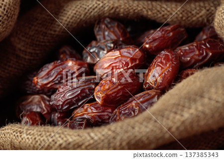 Dates in burlap bag. 137385343