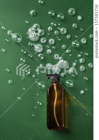 Spray bottle with green liquid and foam on green background 137385738