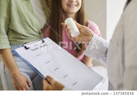 Clipboard with family therapy form and prescription bottle at pediatric visit Clipboard with family therapy form and prescription bottle at pediatric visit 137385838