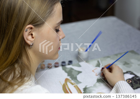 Focusing on her favorite activity instead of work. In her free time, she paints and enjoys moments of peace and quiet. She escapes routine and life and dedicates herself to her beloved art 137386145
