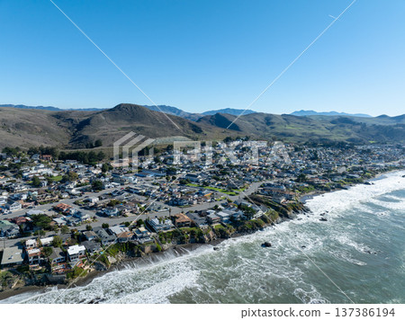 Aerial view of Cayucos, California USA, Pier, Ocean Ave and Shoreline Beach with Green Hills in San Luis Obispo County Aerial view of Cayucos, California USA, Pier, Ocean Ave and Shoreline Beach with Green Hills in San Luis Obispo County 137386194
