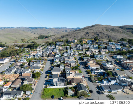Aerial view of Cayucos, California USA, Pier, Ocean Ave and Shoreline Beach with Green Hills in San Luis Obispo County 137386200