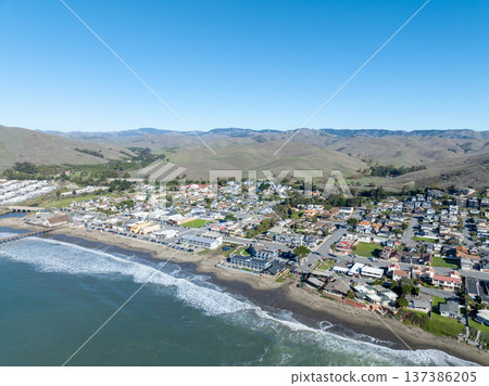 Aerial view of Cayucos, California USA, Pier, Ocean Ave and Shoreline Beach with Green Hills in San Luis Obispo County 137386205