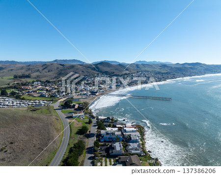 Aerial view of Cayucos, California USA, Pier, Ocean Ave and Shoreline Beach with Green Hills in San Luis Obispo County 137386206