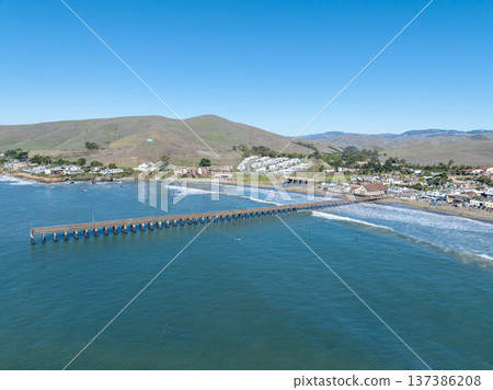Aerial view of Cayucos, California USA, Pier, Ocean Ave and Shoreline Beach with Green Hills in San Luis Obispo County 137386208