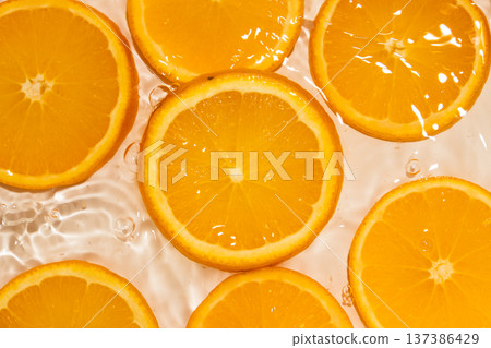 Top view of orange slices in splashing water. Top view of orange slices in splashing water. 137386429