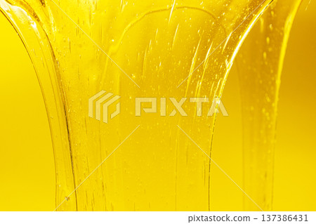 Flowing golden honey with air bubbles texture. 137386431