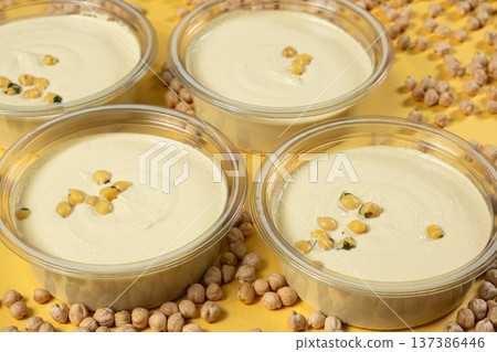 Hummus bowls with whole chickpeas on yellow background. Hummus bowls with whole chickpeas on yellow background. 137386446