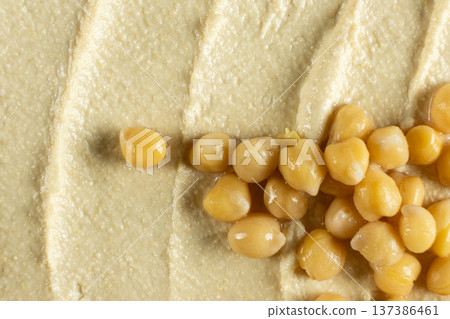 Boiled chickpeas on top of hummus texture macro Boiled chickpeas on top of hummus texture macro 137386461
