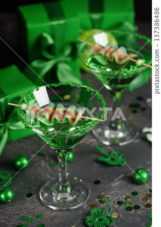 Green Cocktails with Rainbow Candy, shamrocks, Gifts and Confetti. Festive St. Patricks Day Celebration Still Life Green Cocktails with Rainbow Candy, shamrocks, Gifts and Confetti. Festive St. Patricks Day Celebration Still Life 137386486