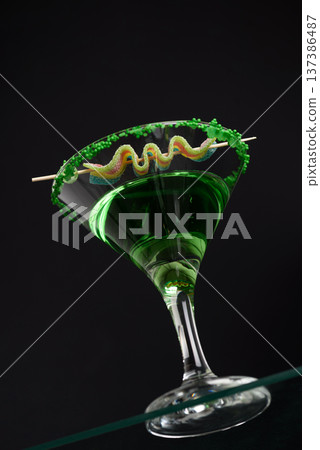 Green Cocktails with Rainbow Candy and Shamrocks. Festive St. Patricks Day Celebration Still Life. Low angle View Green Cocktails with Rainbow Candy and Shamrocks. Festive St. Patricks Day Celebration Still Life. Low angle View 137386487