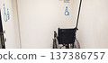 A wheelchair in a designated area for people with disabilities inside the building. The concept of inclusive infrastructure and support for people with disabilities. 137386757