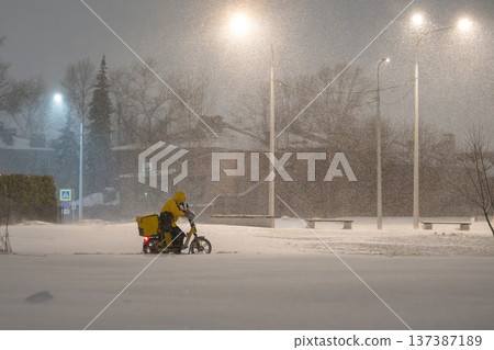 Unrecognizable delivery driver on motorbike stuck in thick snow under heavy snowfall and blizzard. Unrecognizable delivery driver on motorbike stuck in thick snow under heavy snowfall and blizzard. 137387189