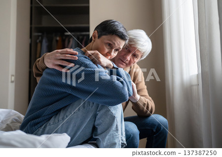 Manipulative abusive husband trying to make peace with depressed apathetic wife after conflict. 137387250