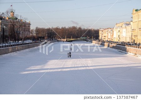 People walking along on frozen rivers and canals in St. Petersburg, Russia on cold winter day. People walking along on frozen rivers and canals in St. Petersburg, Russia on cold winter day. 137387467