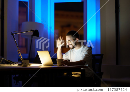 Young businessman, student or lecturer look in laptop web camera waving hand record online webinar 137387524