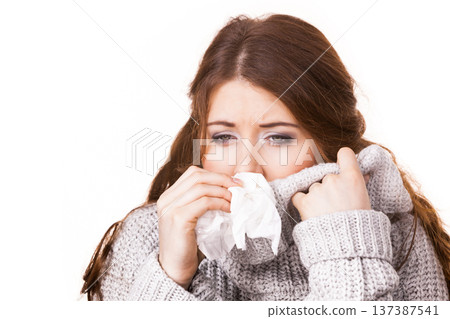 Sick freezing woman sneezing in tissue Sick freezing woman sneezing in tissue 137387541