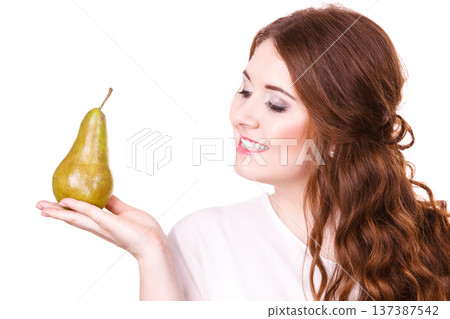 Woman holding pear fruit, isolated. Healthy diet. Woman holding pear fruit, isolated. Healthy diet. 137387542