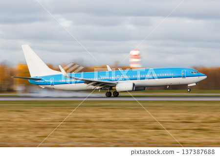 Passenger airplane landing with touchdown on the runway at the airport at sunset, moving Passenger airplane landing with touchdown on the runway at the airport at sunset, moving 137387688