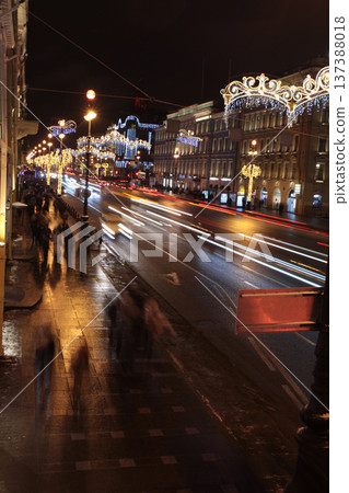Blurred silhouettes of people on the sidewalk at night 137388018