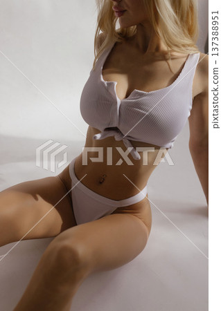Sexy busty blonde woman with large breasts in white lingerie, beauty body care and plastic surgery concept Sexy busty blonde woman with large breasts in white lingerie, beauty body care and plastic surgery concept 137388951