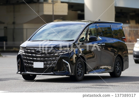 A black luxury minivan in motion A black luxury minivan in motion 137389317