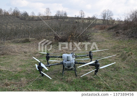 Agricultural drone spraying crop protection mist over pruned orchard for precision smart farming and aerial application Agricultural drone spraying crop protection mist over pruned orchard for precision smart farming and aerial application 137389456