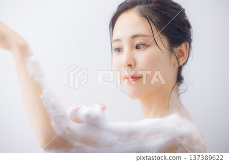 Women washing their body with body soap Women washing their body with body soap 137389622