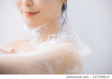 Women washing their body with body soap Women washing their body with body soap 137389624