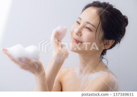 Women washing their body with body soap Women washing their body with body soap 137389631