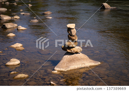 Zen Stone Balance in Calm River Water Zen Stone Balance in Calm River Water 137389669