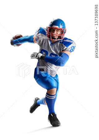 American football player in action. Football game. A young agile American football player runs fast. Sports attack. Isolated American football player in action. Football game. A young agile American football player runs fast. Sports attack. Isolated 137389698