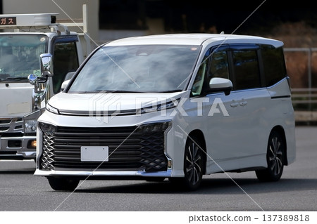 A white minivan in motion A white minivan in motion 137389818