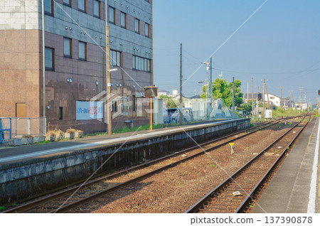 A view of a local station platform and train tracks 137390878