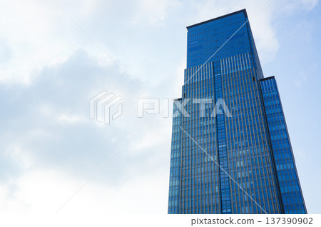 Modern skyscrapers towering under the blue sky Modern skyscrapers towering under the blue sky 137390902